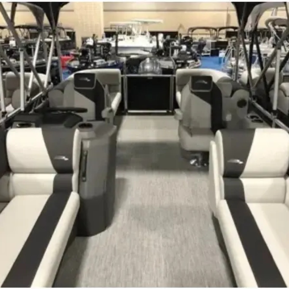 Interior view of a pontoon boat with beige and gray seating.