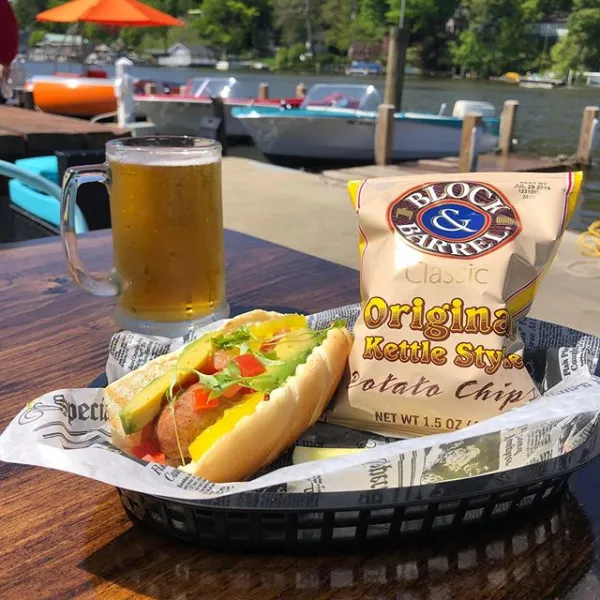 a cup of hot dogs sitting on a table