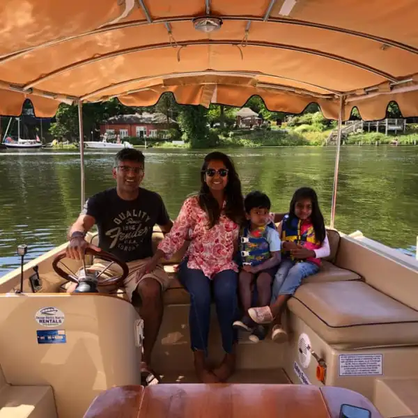 a group of people sitting on a boat in the water