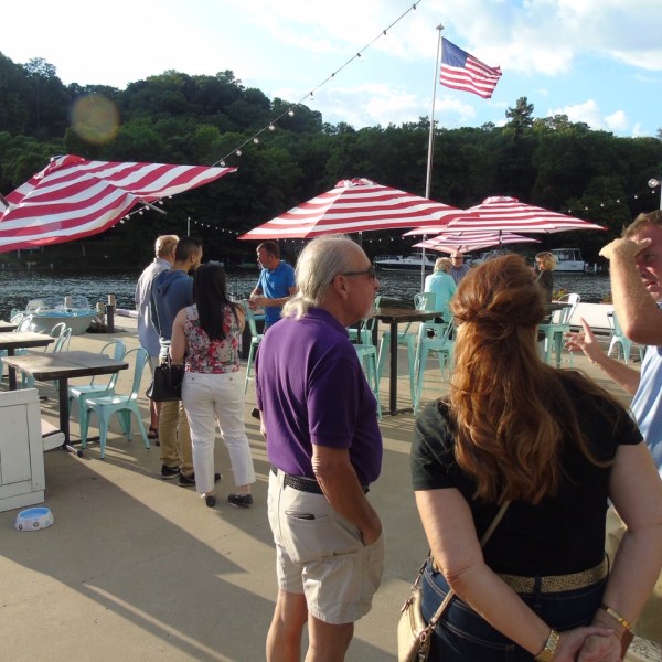 a group of people standing next to an umbrella
