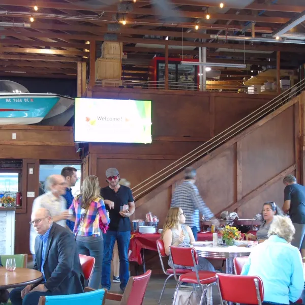 a group of people sitting at a table in a restaurant