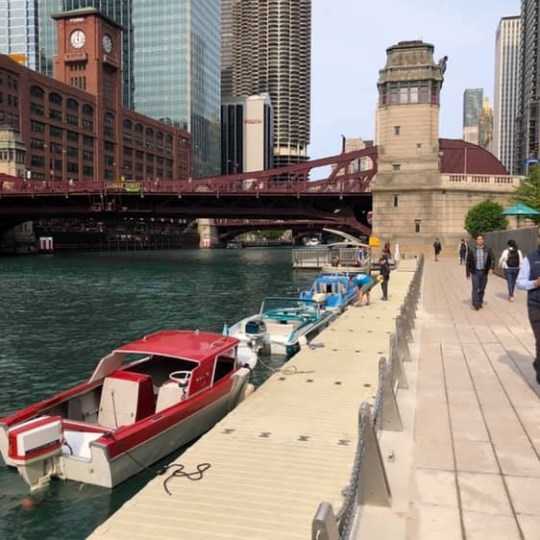 a small boat in a body of water with a city in the background