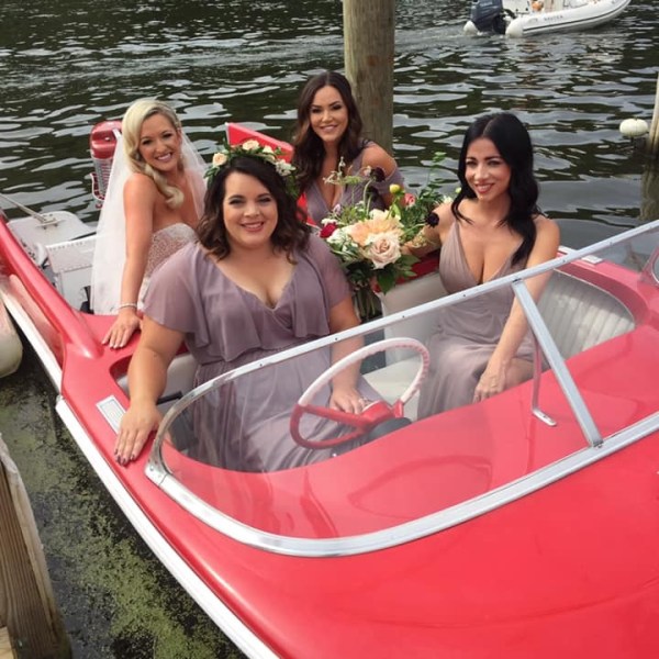 Angela James et al. in a boat on a body of water