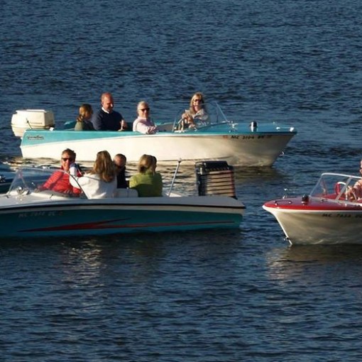 a group of people in a small boat in a body of water